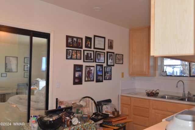 kitchen featuring a sink, light brown cabinetry, and light countertops