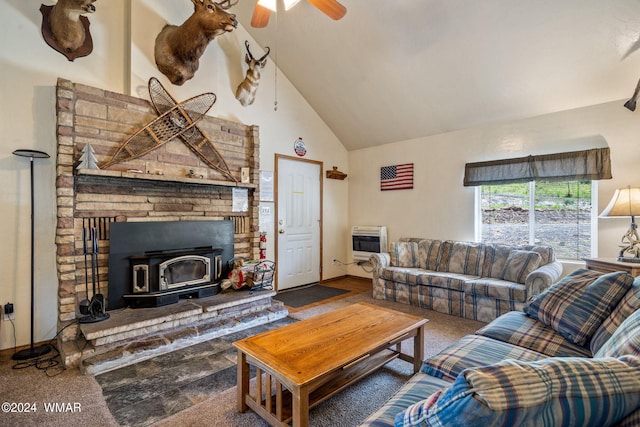 carpeted living area featuring heating unit, a wood stove, high vaulted ceiling, and a ceiling fan