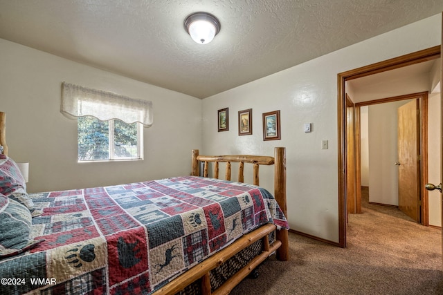 carpeted bedroom featuring a textured ceiling