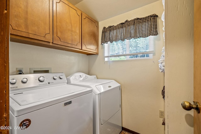 clothes washing area featuring cabinet space and washing machine and clothes dryer