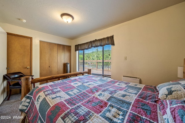 carpeted bedroom with a textured ceiling