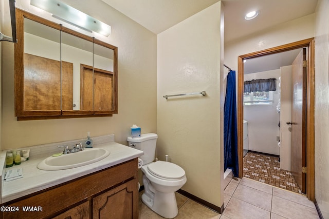 bathroom featuring toilet, tile patterned flooring, and vanity