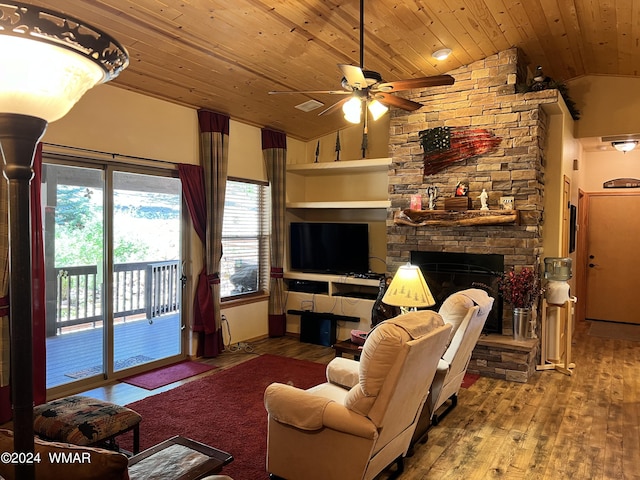 living room featuring wooden ceiling, vaulted ceiling, a stone fireplace, and wood finished floors