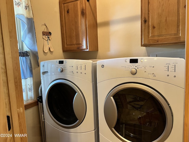 laundry area featuring washer and dryer and cabinet space