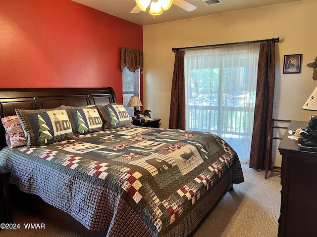 carpeted bedroom with ceiling fan, access to outside, and visible vents