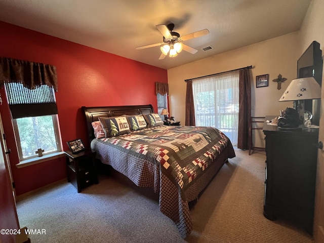 bedroom featuring ceiling fan, visible vents, and light colored carpet