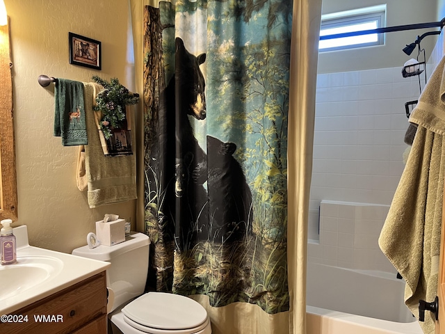 full bathroom with toilet, vanity, shower / bath combination with curtain, and a textured wall