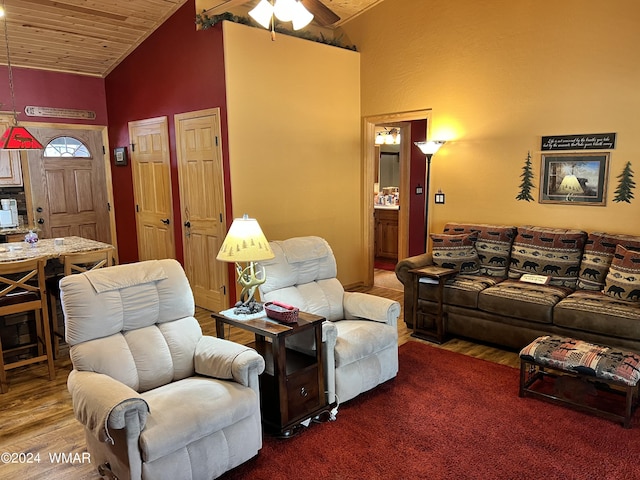 living area featuring high vaulted ceiling, wooden ceiling, wood finished floors, and a ceiling fan