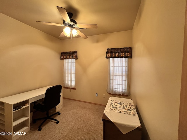 unfurnished office with ceiling fan, carpet flooring, and baseboards