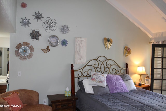 bedroom featuring high vaulted ceiling