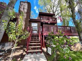 back of property featuring stairway and a deck