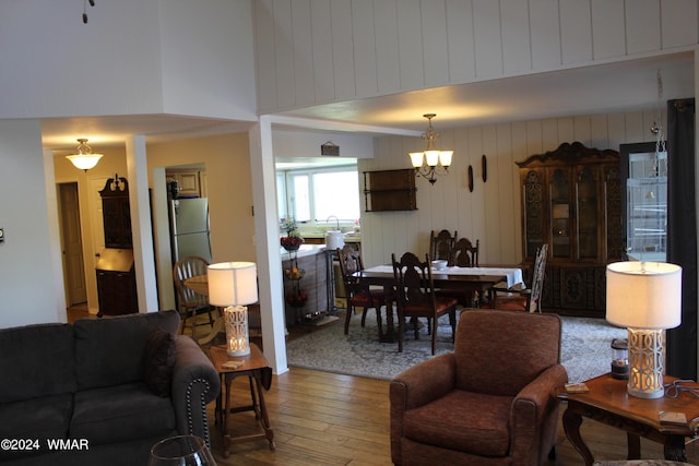 living area with hardwood / wood-style floors and a towering ceiling