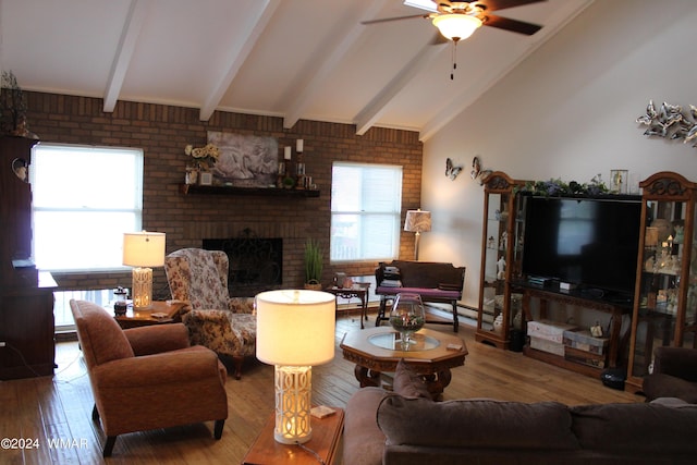 living room with ceiling fan, a fireplace, vaulted ceiling with beams, and hardwood / wood-style flooring