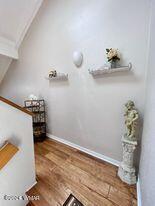 interior space with lofted ceiling and wood finished floors