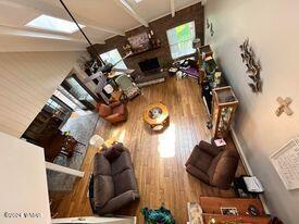living area featuring wood finished floors and a fireplace