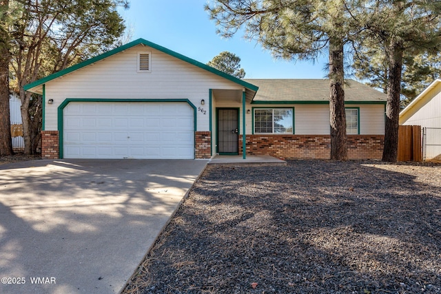 single story home with an attached garage, driveway, fence, and brick siding