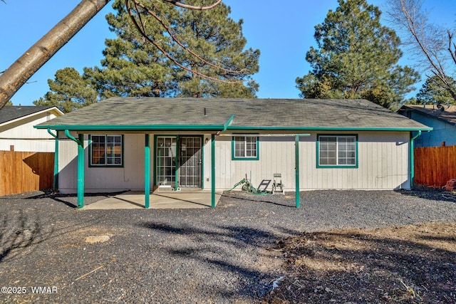 back of house with a patio and fence