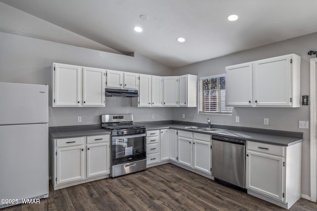 kitchen featuring appliances with stainless steel finishes, dark countertops, white cabinets, and under cabinet range hood