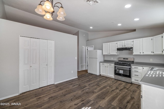 kitchen featuring light countertops, visible vents, freestanding refrigerator, white cabinetry, and gas range