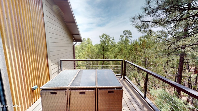 wooden deck featuring a view of trees