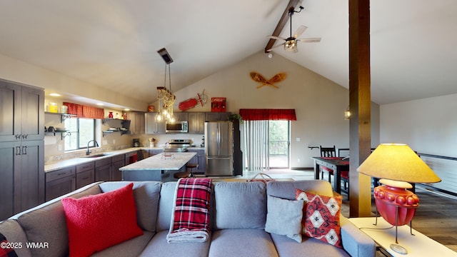 living area featuring high vaulted ceiling, beamed ceiling, a ceiling fan, and light wood-type flooring