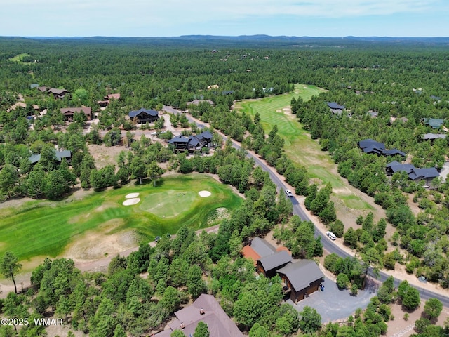 aerial view with a residential view, a wooded view, and golf course view