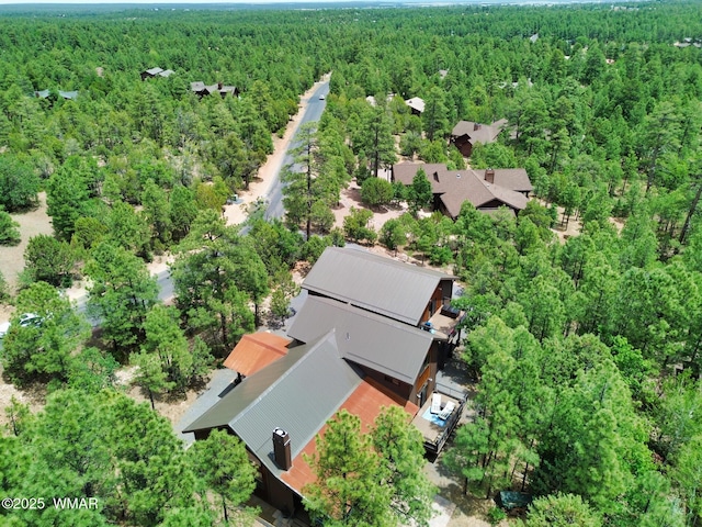 drone / aerial view featuring a forest view