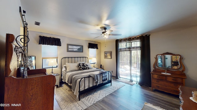 bedroom featuring access to outside, a ceiling fan, wood finished floors, and visible vents