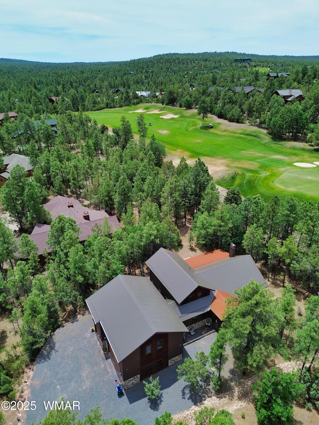 birds eye view of property featuring a forest view and golf course view