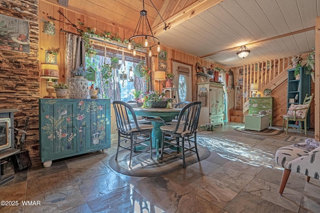 3738 Apache Trl, Pine, AZ 85544 - dining room with stone tile floors, wood ceiling, wood walls, and a wood stove