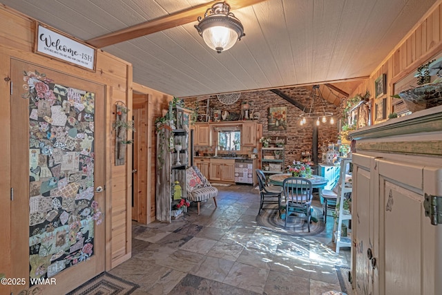 3738 Apache Trl, Pine, AZ 85544 - foyer entrance with wood ceiling, vaulted ceiling, stone finish flooring, wooden walls, and a wood stove