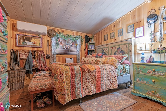 3738 Apache Trl, Pine, AZ 85544 - bedroom featuring a wall mounted AC, wooden walls, hardwood / wood-style floors, and wooden ceiling