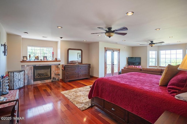 1961 S Canyon Ridge Trl, Show Low, AZ 85901 - bedroom featuring a tile fireplace, recessed lighting, wood-type flooring, and french doors