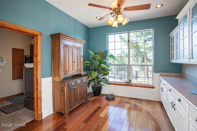 1961 S Canyon Ridge Trl, Show Low, AZ 85901 - dining space with healthy amount of natural light, light wood-style floors, ceiling fan, recessed lighting, and wainscoting
