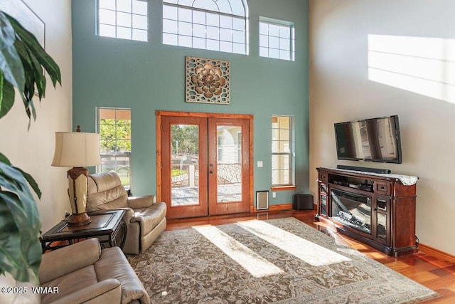 1961 S Canyon Ridge Trl, Show Low, AZ 85901 - living area with french doors, a towering ceiling, wood finished floors, and baseboards
