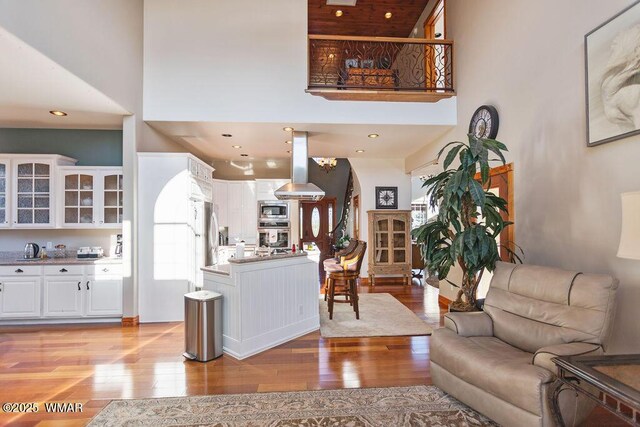 1961 S Canyon Ridge Trl, Show Low, AZ 85901 - living room featuring a high ceiling, light wood finished floors, and arched walkways