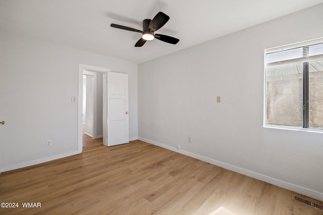 unfurnished bedroom with visible vents, ceiling fan, light wood-style flooring, and baseboards