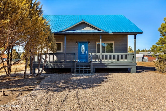 view of front facade featuring a porch and metal roof