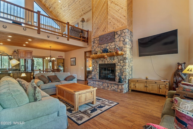 5621 E Starlight Ridge Rd, Lakeside, AZ 85929 - living area with high vaulted ceiling, a chandelier, light wood-type flooring, a fireplace, and recessed lighting