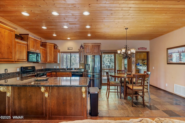 5621 E Starlight Ridge Rd, Lakeside, AZ 85929 - kitchen with black appliances, wooden ceiling, brown cabinetry, a peninsula, and a chandelier