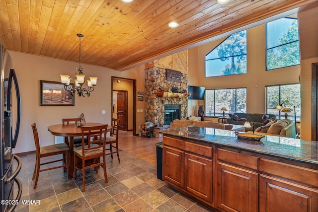 5621 E Starlight Ridge Rd, Lakeside, AZ 85929 - kitchen with fridge, wood ceiling, a fireplace, a chandelier, and recessed lighting