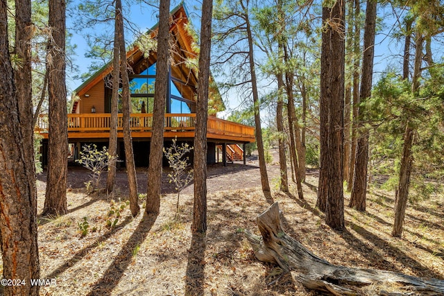 exterior space with a deck and stairs