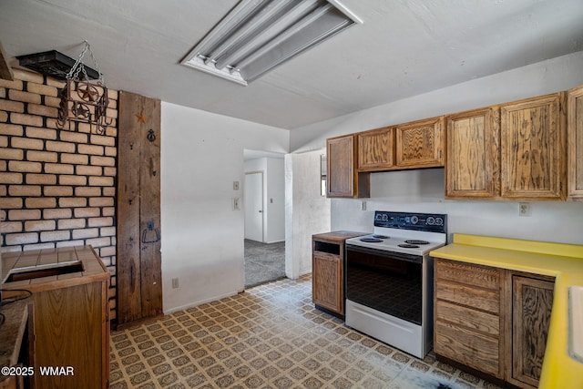 1720 E Becker Lane Loop, Springerville, AZ 85938 - kitchen with white electric stove, brown cabinetry, and light floors
