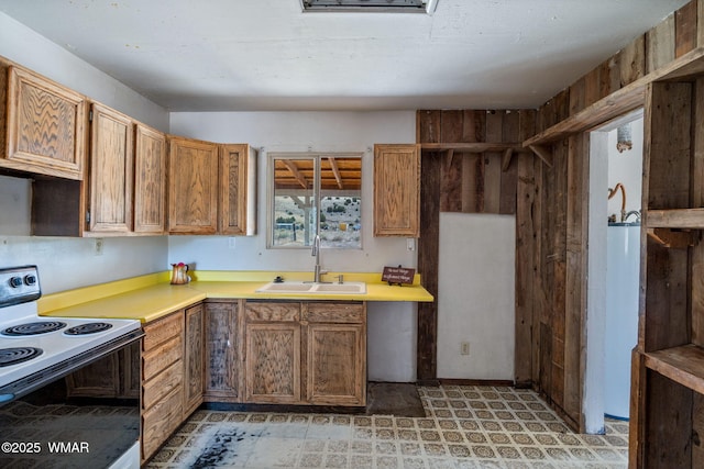 1720 E Becker Lane Loop, Springerville, AZ 85938 - kitchen with electric stove, light countertops, gas water heater, light floors, and brown cabinets