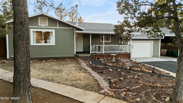 ranch-style home with a porch, a shingled roof, fence, a garage, and driveway