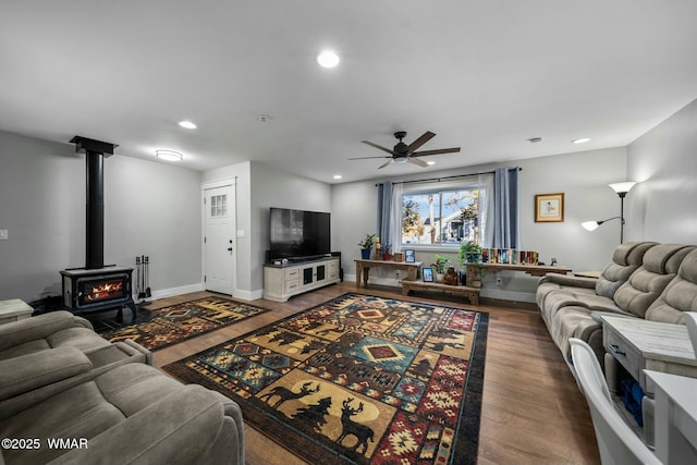 living area featuring baseboards, wood finished floors, and recessed lighting