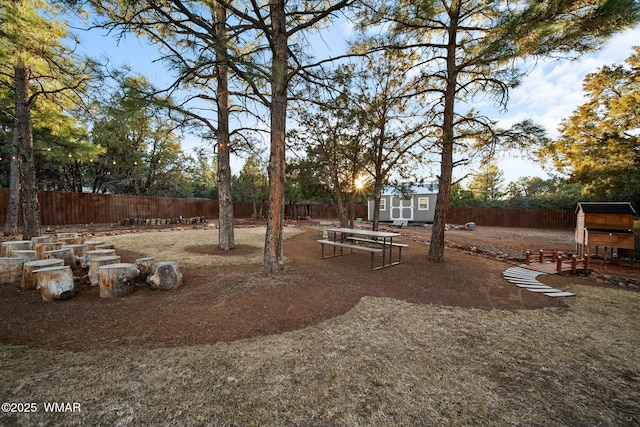 view of yard with an outbuilding, a shed, and a fenced backyard