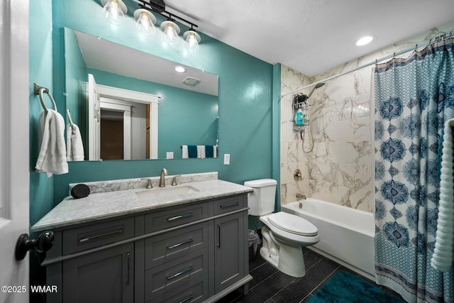 bathroom featuring toilet, shower / tub combo, and vanity