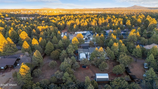 birds eye view of property with a view of trees