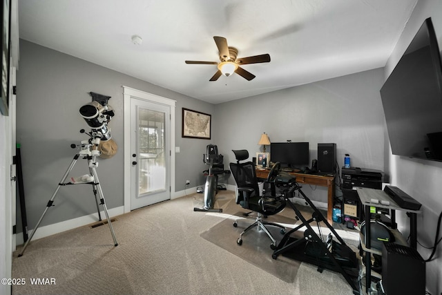 home office featuring carpet flooring, a ceiling fan, and baseboards